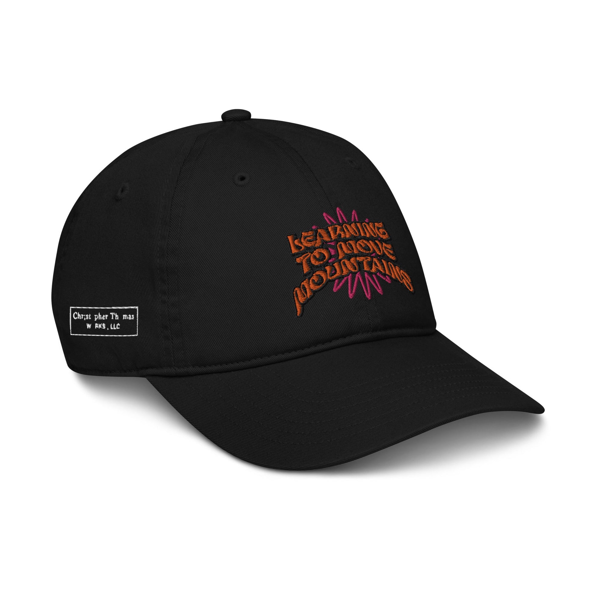 The Eintou black baseball cap from 17th & Granville is crafted from organic cotton and showcases vibrant embroidered text on the front with the message "Learning to Move Mountains." Additionally, a subtle label featuring white text is positioned on the side.