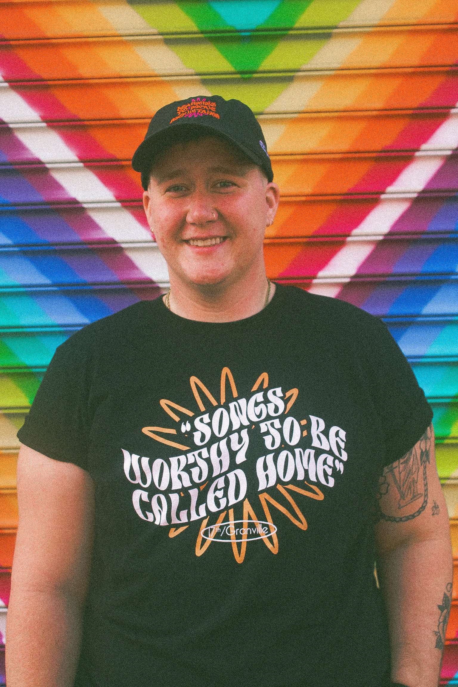 Model wearing Eintou Hat and T-shirt from the Eintou Collection by 17th & Granville, featuring organic materials and embroidered poetry, part of a fashion activism collaboration supporting BIPOC and LGBTQ+ communities.