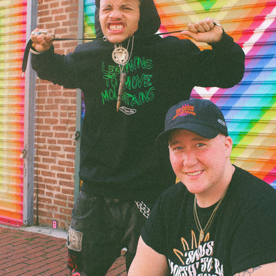 Models wearing Eintou Collection: Black organic hoodie, hat, and t-shirt. BIPOC and LGBTQ+ representation in fashion activism collab between C. Alexandria Bernard Thomas and 17th & Granville. Proceeds support marginalized communities.