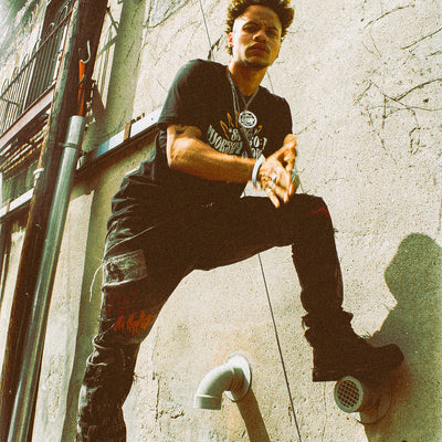 Black organic cotton hat and t-shirt from the Eintou Collection by 17th & Granville, featuring embroidered design with poetry snippets, part of a fashion activism collaboration supporting BIPOC and LGBTQ+ communities.