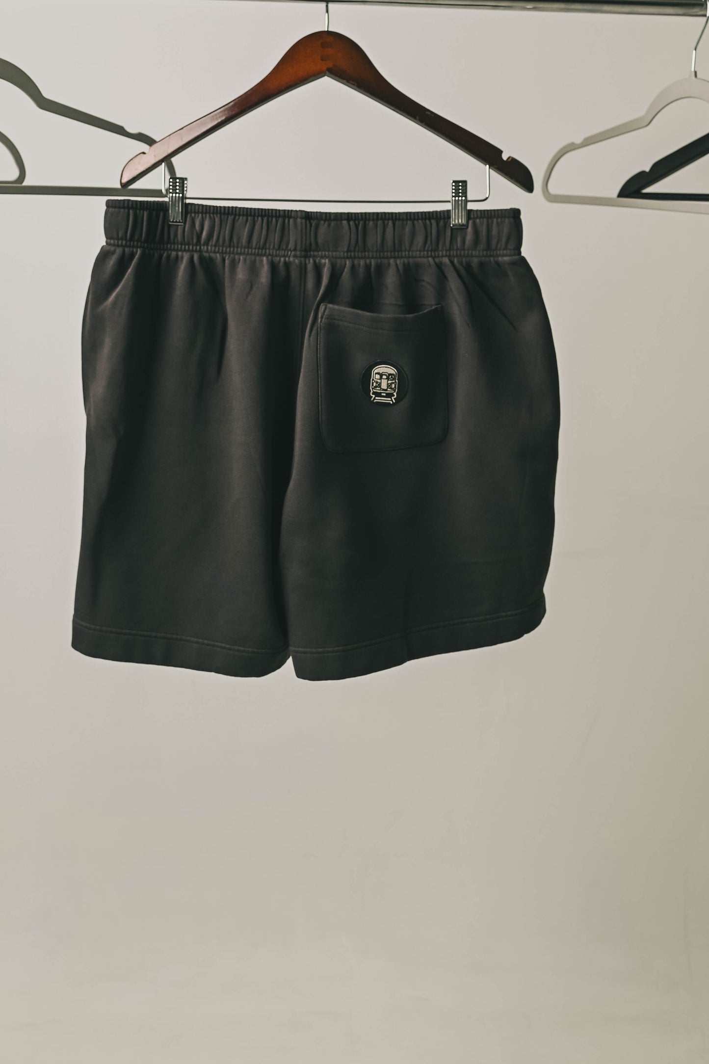 We Show Up Shorts with embroidered emblem on the back pocket.