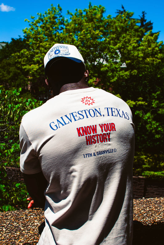Model facing away wearing Juneteenth tee, revealing back design with ‘Galveston, Texas’ and ‘Know Your History’ in bold red and blue text