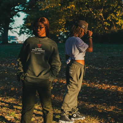 Models wearing the Love You More sweatshirt and sweatpants together.