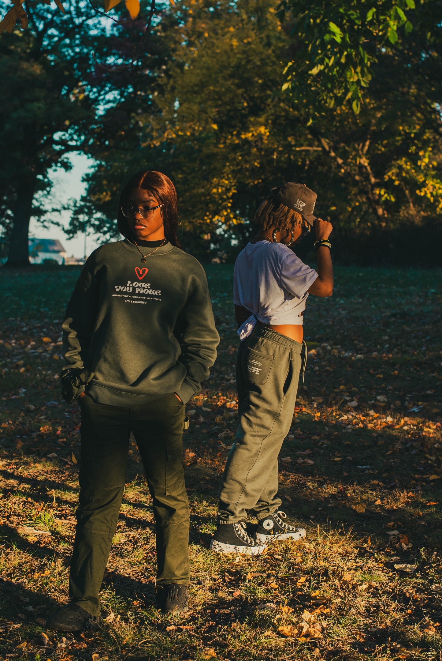 Models wearing the Love You More sweatshirt and sweatpants together.