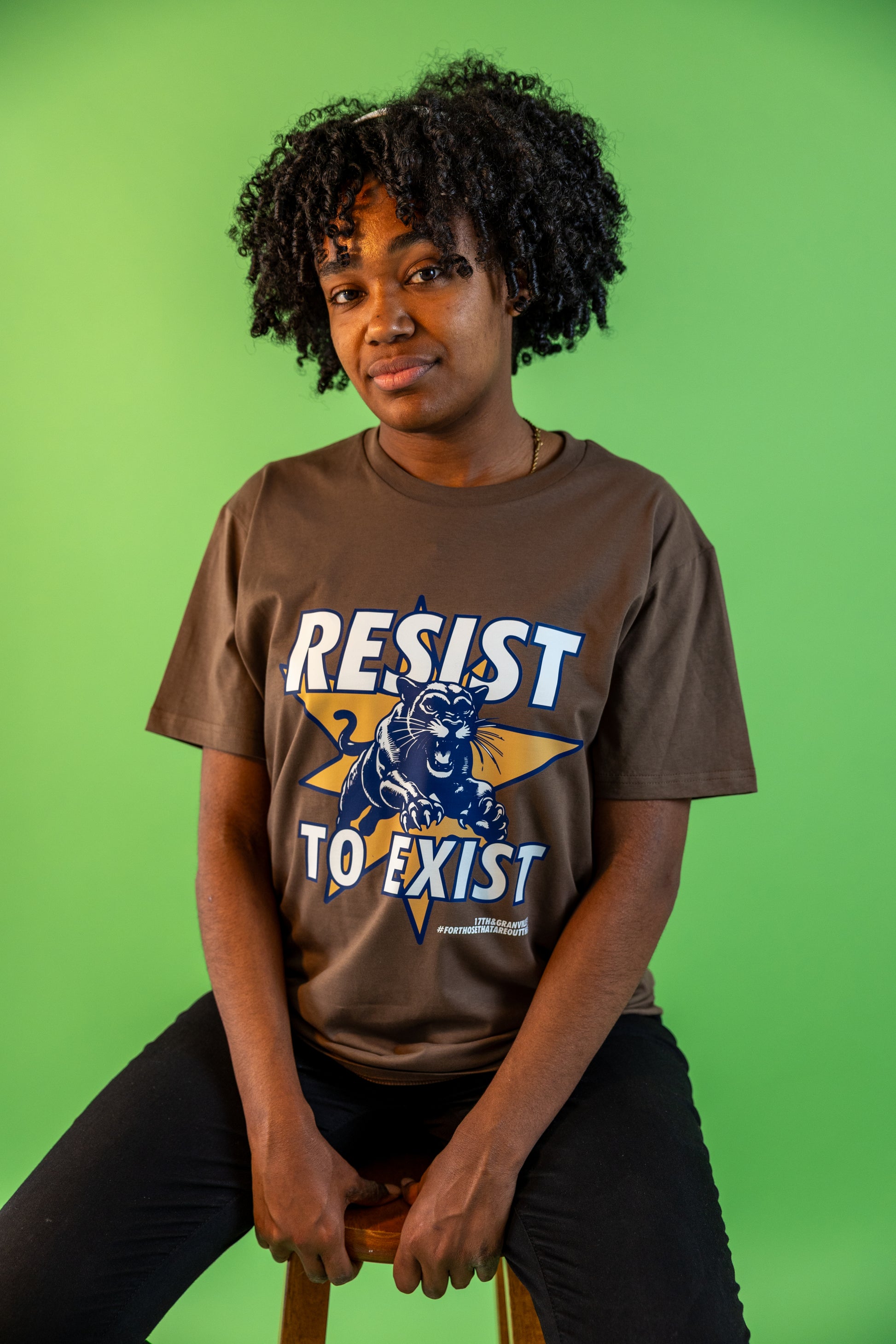 Model wearing the Resist tee with the design clearly visible.